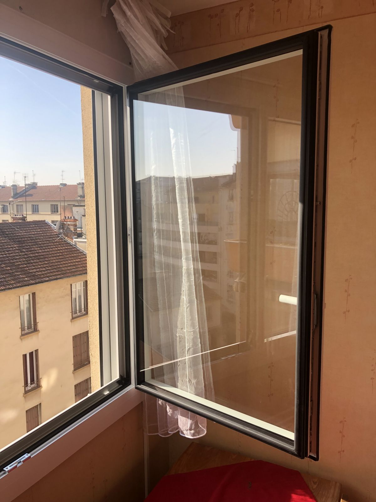 Fenêtre aluminium gris foncé, vantail ouvert à la française, en étage
